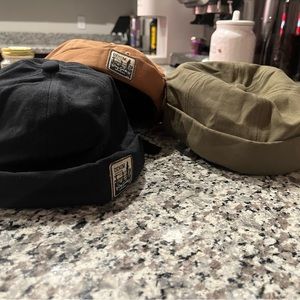 Bundle of brimless adjustable hats.